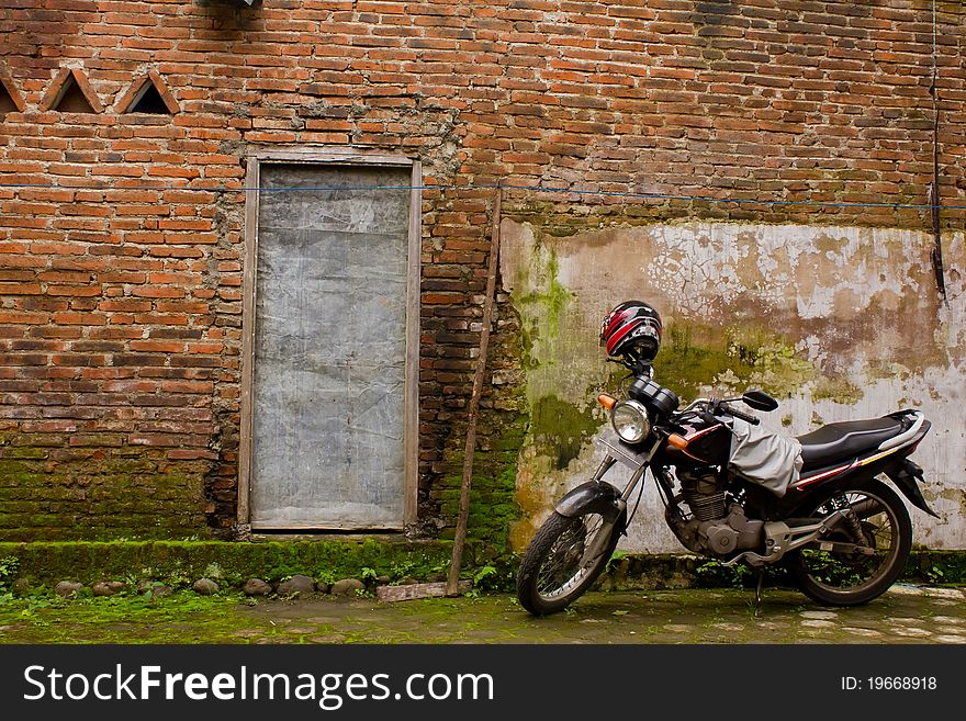 Motorcycle parking near old red brick wall. Motorcycle parking near old red brick wall