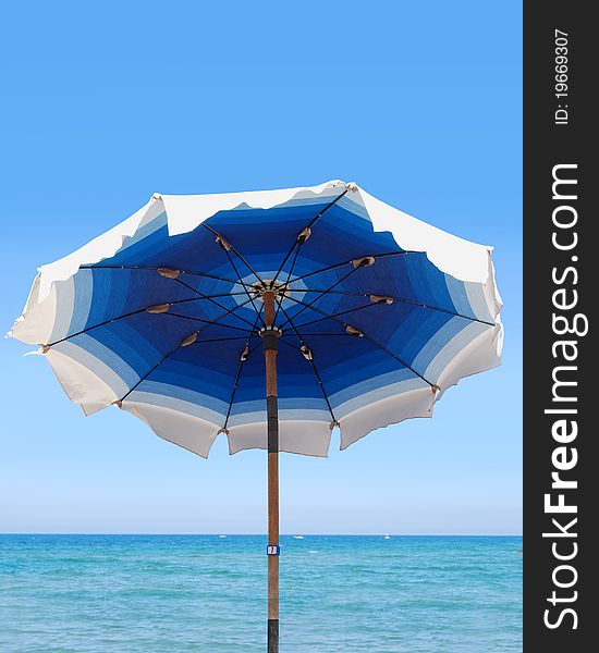 Blue and white umbrella in the beach. Blue and white umbrella in the beach