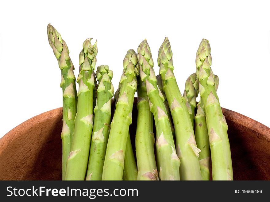 Fresh green asparagus in wooden bowl