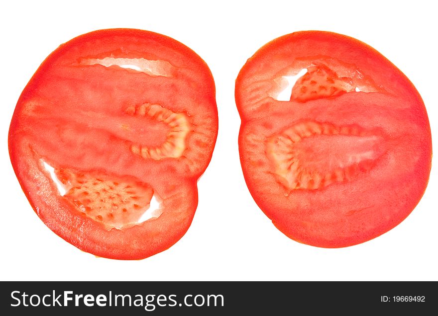 Two slices of red tomato isolated on white