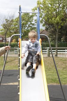 Little Boy Sliding Down A Slide Royalty Free Stock Photography Little Boy Sliding Down A Slide Royalty Free Stock Photography