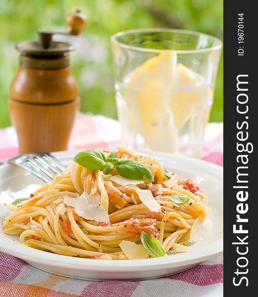 Spaghetti with a tomato sauce, cheese and a basil. Selective focus