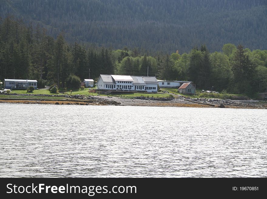 Large home on the beach in Southeastern Alaska with the Tongass National Forest in the background. Large home on the beach in Southeastern Alaska with the Tongass National Forest in the background.