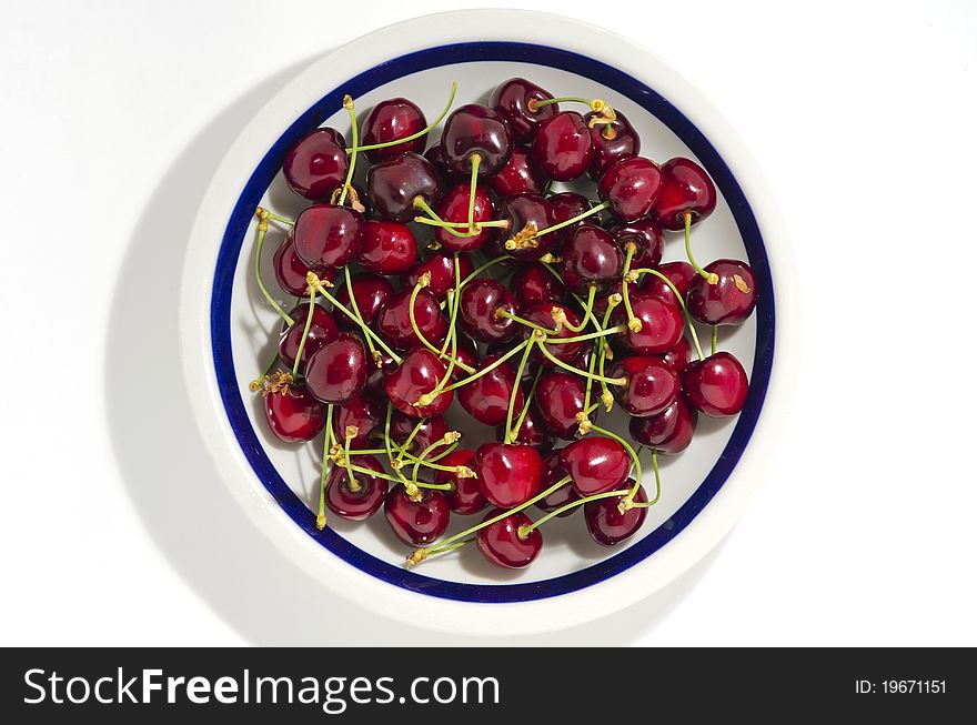 A plate full of fresh cherries. A plate full of fresh cherries