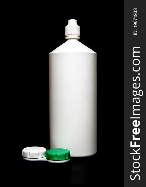 White bottle and contact lens case on black