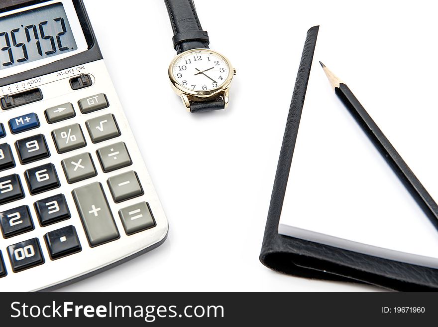 Calculator note pad and watch on white