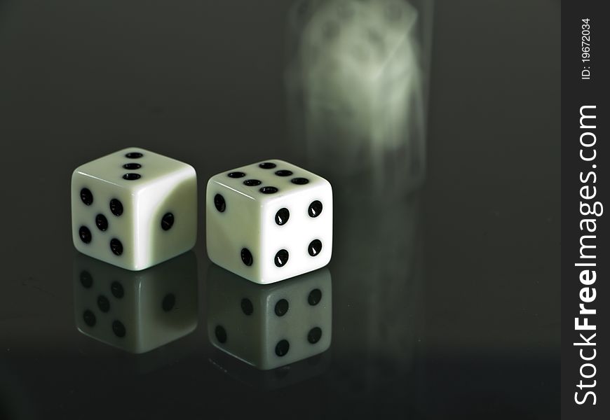 Two white dice and one is dicing