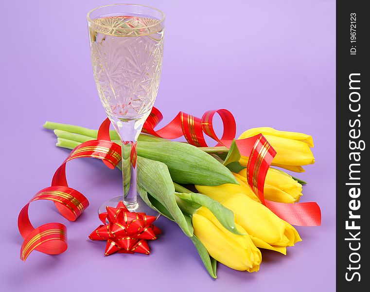 Glass wine and yellow tulips. Glass wine and yellow tulips