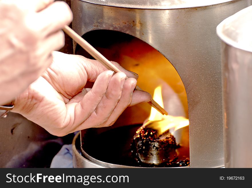 Burn joss sticks on fire