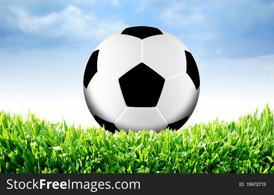 Photo of a football on grass with sky background. Photo of a football on grass with sky background.