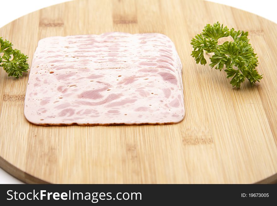 Ham sausage with parsley onto wood plates