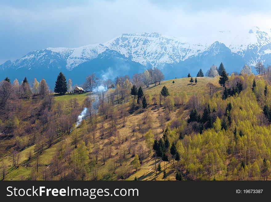 Spring landscape with mountains having snow and green trees on the hills. Spring landscape with mountains having snow and green trees on the hills
