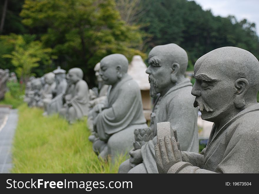 Buddhist Statues in a row at an Asian temple.