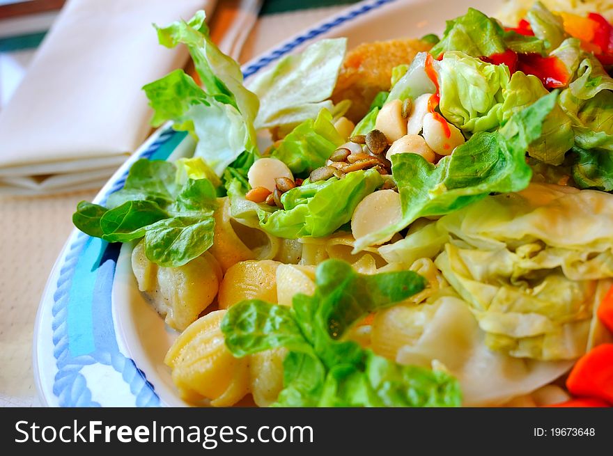 Healthy and fresh vegetable and potato salad topped with salad dressing. Healthy and fresh vegetable and potato salad topped with salad dressing.