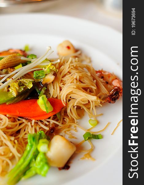 Elaborate Asian style dry vermicelli prepared with healthy vegetable and seafood ingredients. Elaborate Asian style dry vermicelli prepared with healthy vegetable and seafood ingredients.