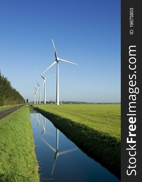 Several windturbines in a green field