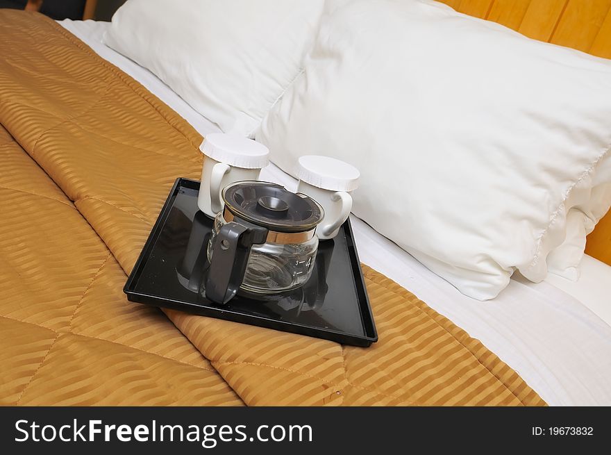 Coffee maker and drink utensils on soft and comfortable bed. Coffee maker and drink utensils on soft and comfortable bed.