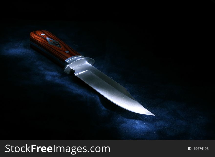 Hunting knife photographed with a light brush