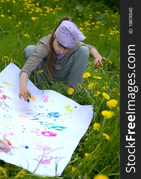 Child painting with paints on the meadow. Child painting with paints on the meadow