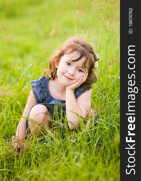 A beautiful young girl in a field of long grass