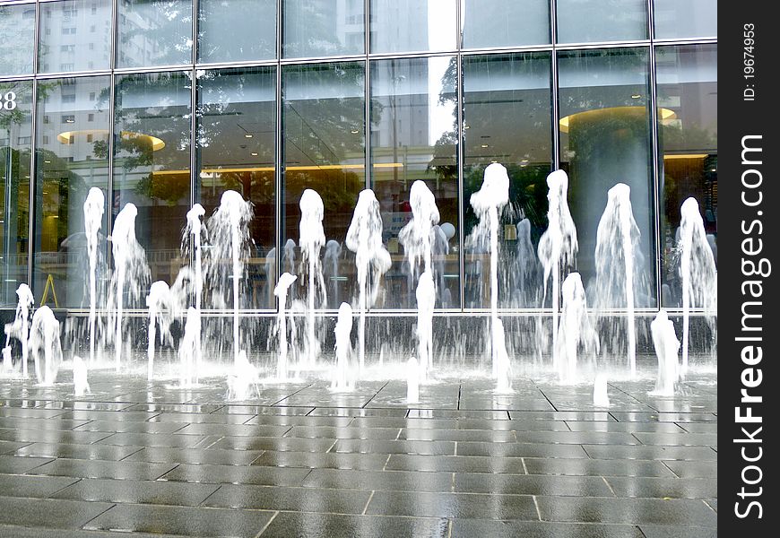 Fountains in front of a building in city. Fountains in front of a building in city