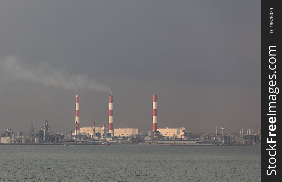 Panoramic view of power plant against overcast sky