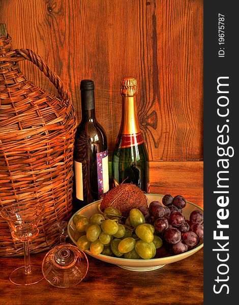 Glasses and grapes, bottles of wine and wooden background. Glasses and grapes, bottles of wine and wooden background.