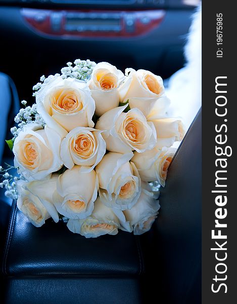 Yellow wedding bouquet in car.