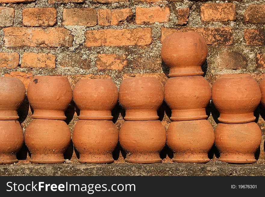 Ceramic pots against a brick wall