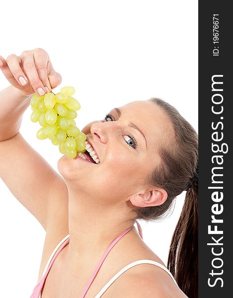 Young woman eating grapes on withe