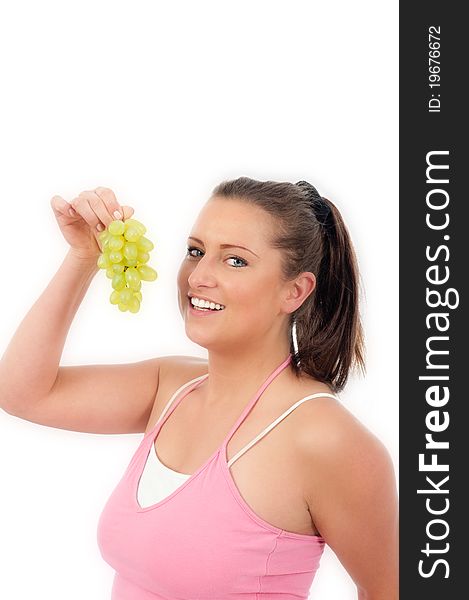 Young woman eating grapes on withe