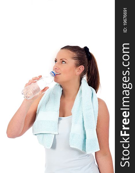 Young woman drinking water after exercise