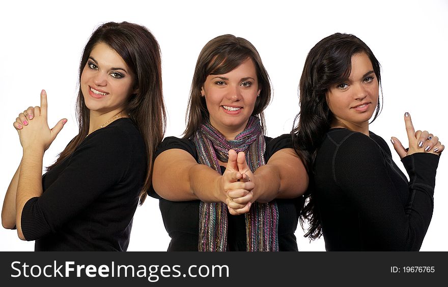 Young adult ladies posing as though they have guns in their hands. Young adult ladies posing as though they have guns in their hands.