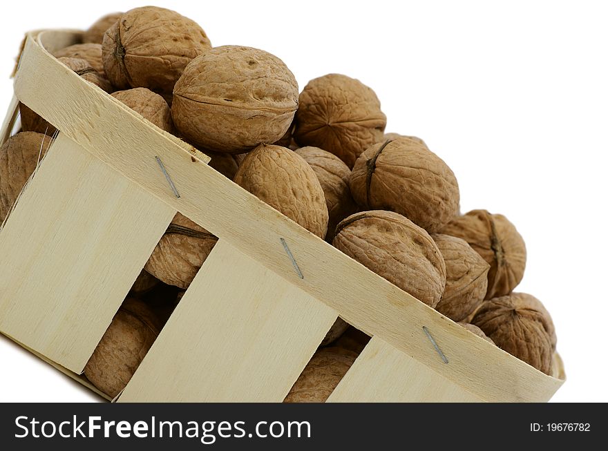 Basket with the walnuts against the white background