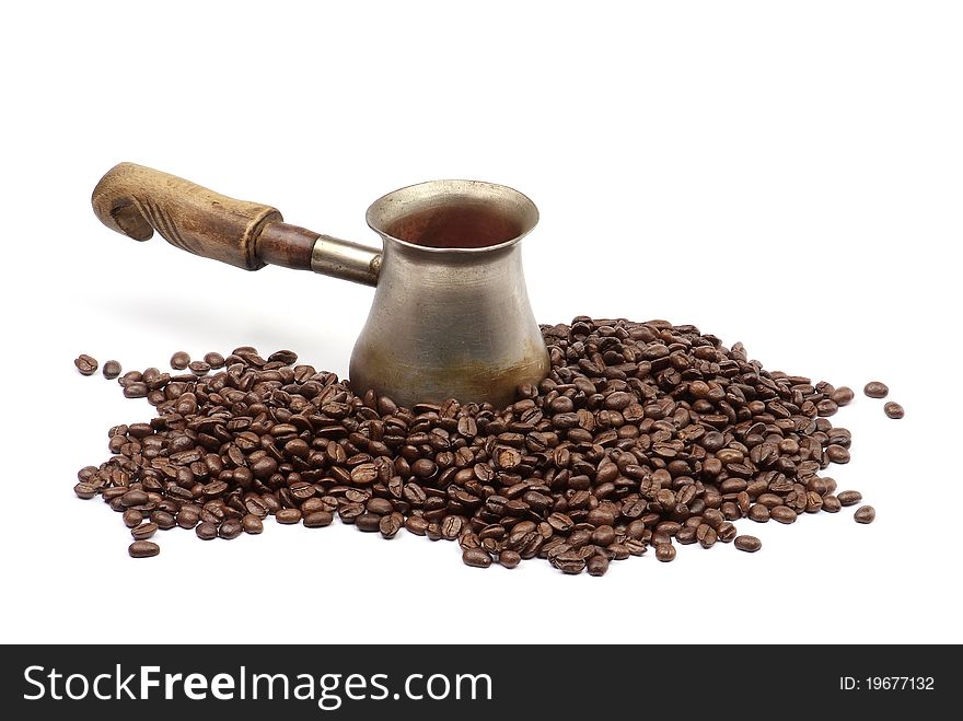Old copper coffee pot with coffee beans isolated on white