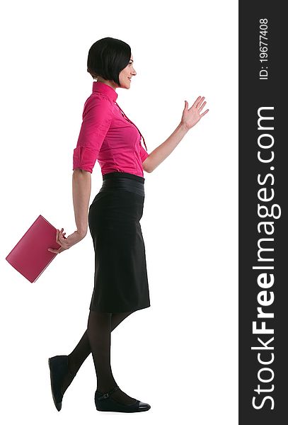 Young businesswoman in pink suit walk forward with book isolated. Young businesswoman in pink suit walk forward with book isolated