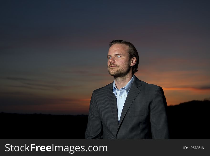 Man in suit standing in sunset. Man in suit standing in sunset