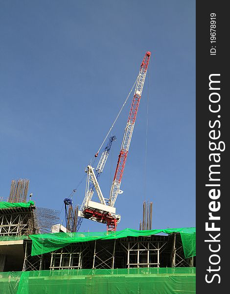 Crane and building construction on blue background