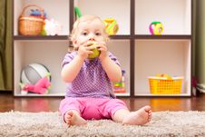 Cute Baby Eating A Green Apple Royalty Free Stock Images