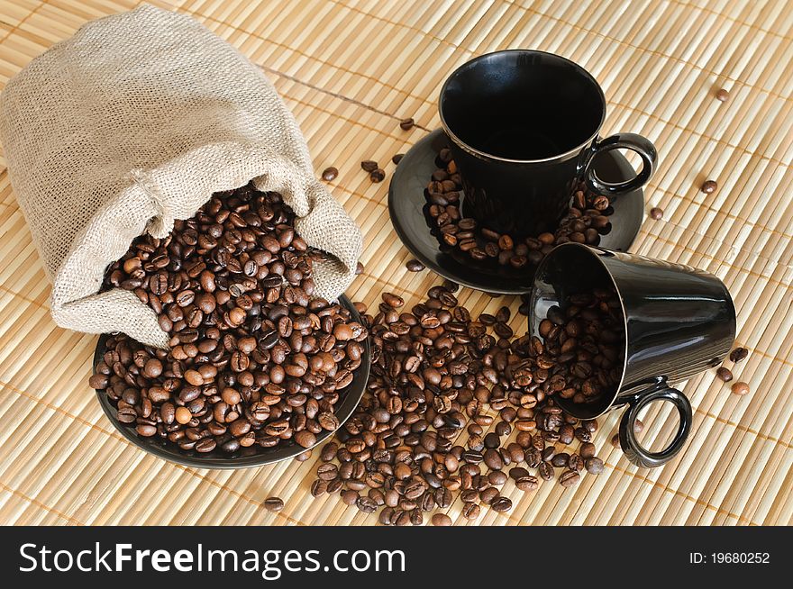 Cooffee beans with black cups and sack. Cooffee beans with black cups and sack