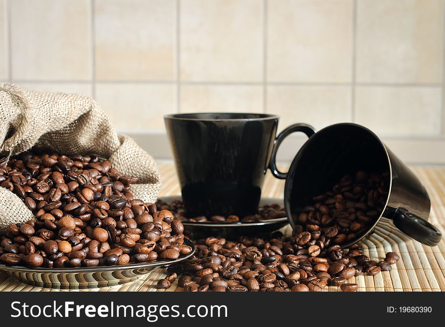 Cooffee beans with black cups and sack. Cooffee beans with black cups and sack