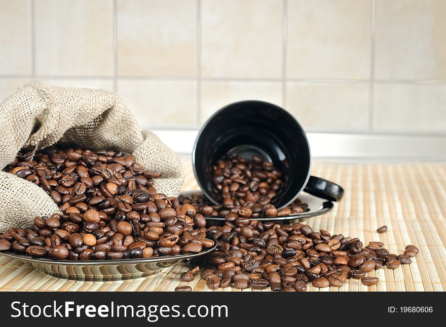 Cooffee beans with black cup and sack