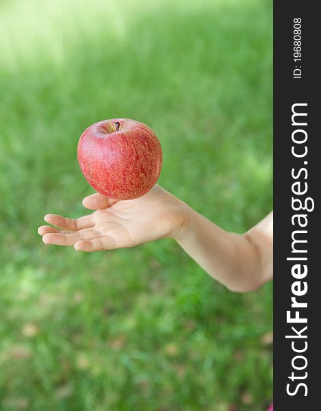 An aerial apple and a hand. An aerial apple and a hand