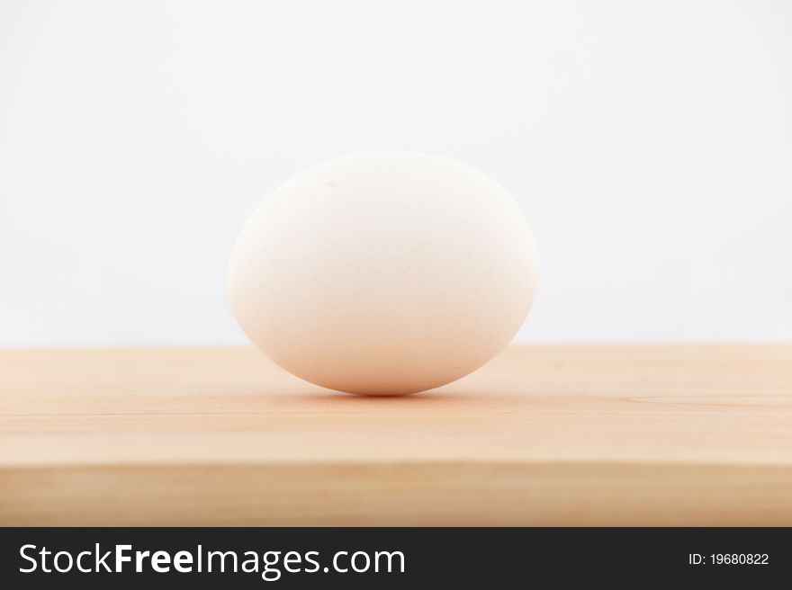 An egg lying on the chopping board. An egg lying on the chopping board