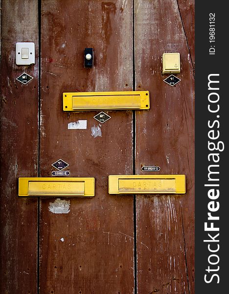 A door with doorbells and mailslots in Lisbon