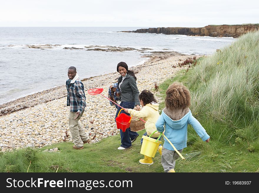 Family on beach collecting shells having fun