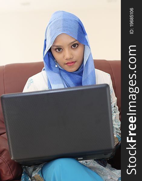 A young muslim woman using laptop. A young muslim woman using laptop