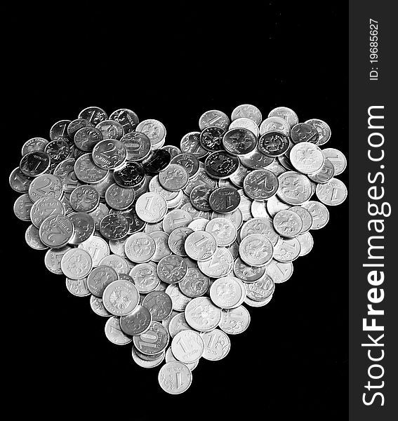 Pile of coins in the form of heart