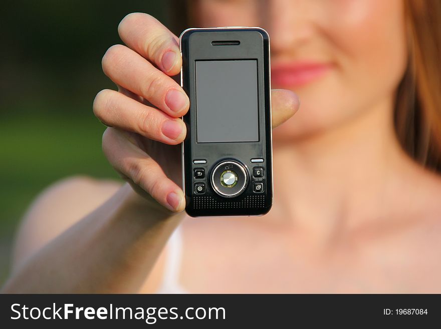 Young girl holding mobile phone. Young girl holding mobile phone