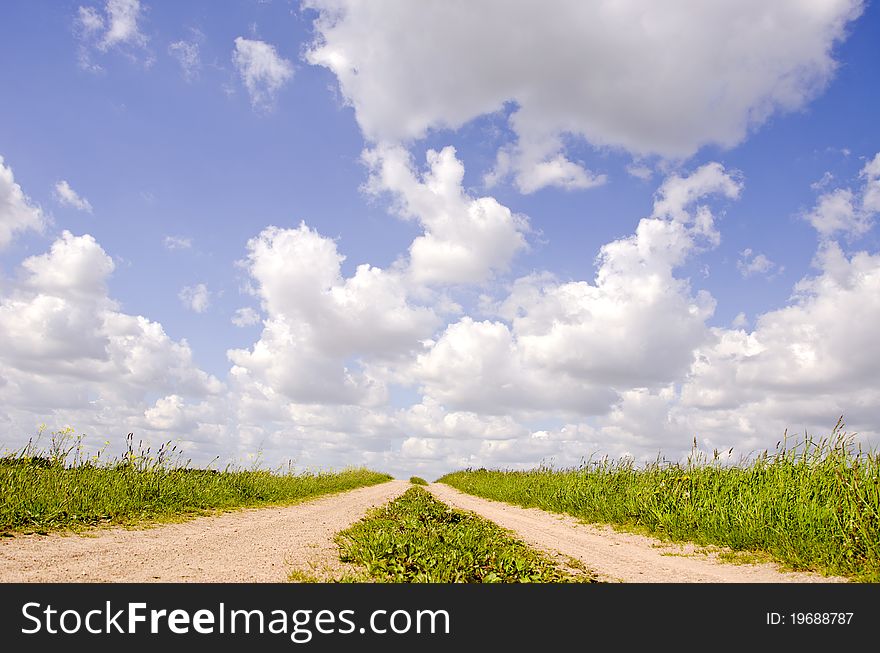 Countryside road with grass and summer clouds. Countryside road with grass and summer clouds